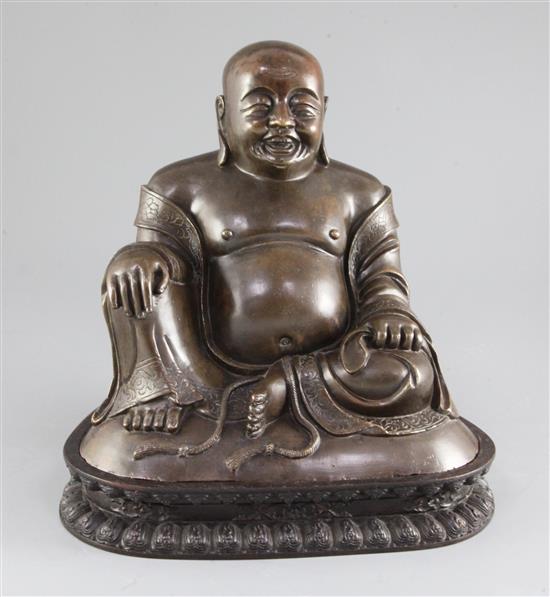 A large Chinese bronze seated figure of Budai, height 23cm excl. lotus carved hardwood stand, total weight 5.95kg